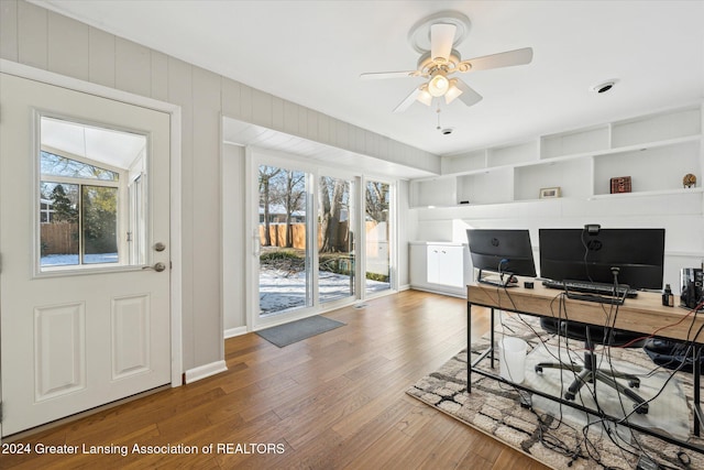 home office featuring ceiling fan, plenty of natural light, and wood-type flooring