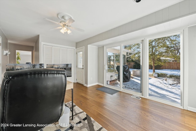 living room with hardwood / wood-style flooring and ceiling fan