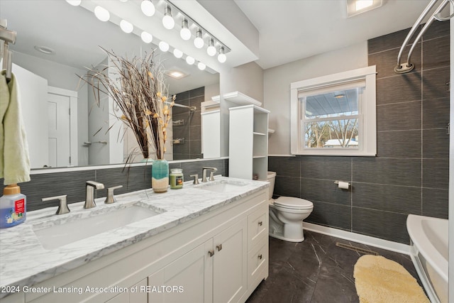 bathroom featuring vanity, tile walls, and toilet