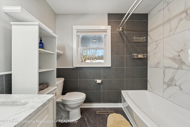 full bathroom featuring vanity, toilet, tile walls, and  shower combination