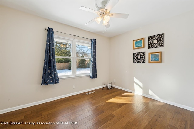 unfurnished room with hardwood / wood-style floors and ceiling fan