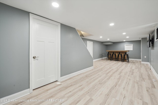 basement with light hardwood / wood-style floors