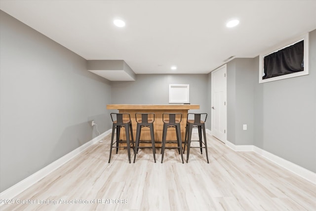 bar featuring light hardwood / wood-style floors