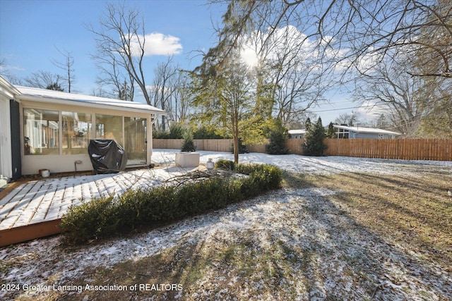 view of yard with a wooden deck and a sunroom