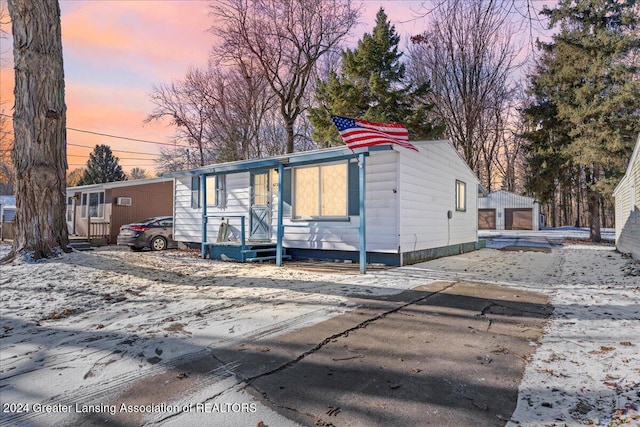 manufactured / mobile home with a garage and an outdoor structure