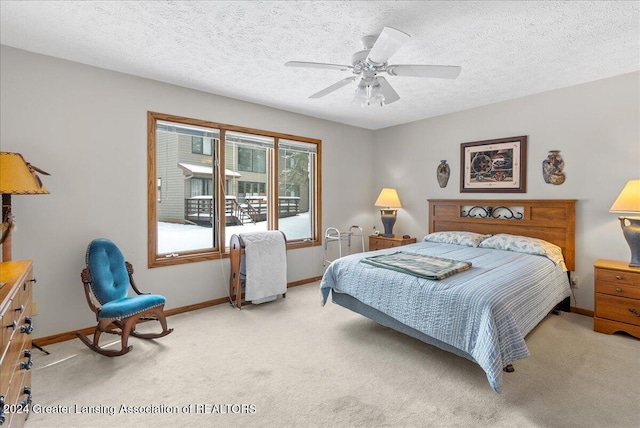 carpeted bedroom with a textured ceiling and ceiling fan