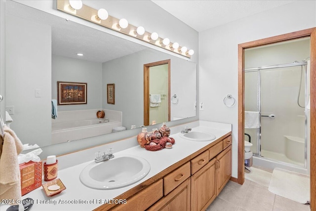 full bathroom featuring a textured ceiling, tile patterned flooring, toilet, vanity, and plus walk in shower