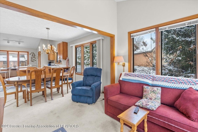 carpeted living room featuring lofted ceiling, an inviting chandelier, and a textured ceiling