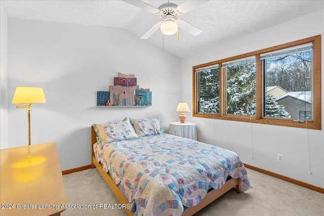 carpeted bedroom featuring ceiling fan, lofted ceiling, and a textured ceiling