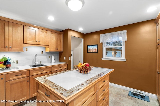 kitchen with sink, backsplash, and a center island