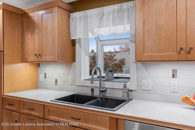 kitchen with decorative backsplash, sink, and dishwasher