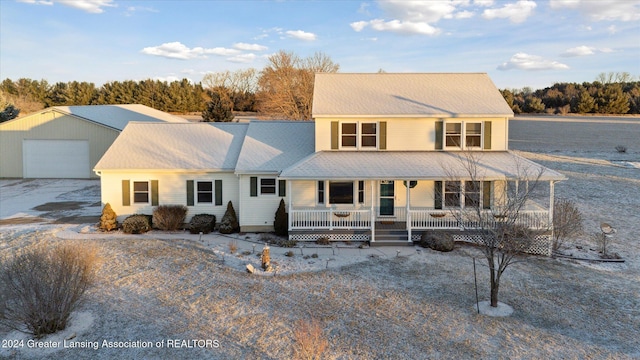 view of front of home featuring an outbuilding, a porch, and a garage