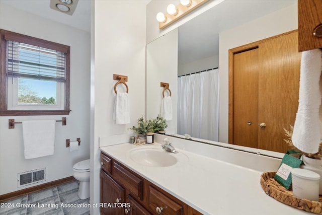 bathroom featuring vanity and toilet