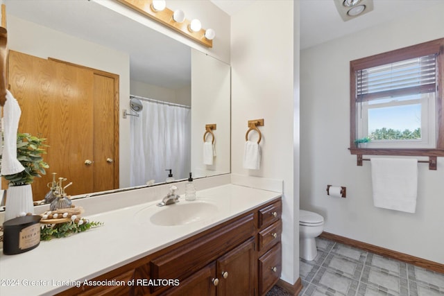 bathroom featuring vanity and toilet