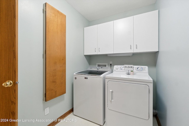 laundry room featuring cabinets and separate washer and dryer