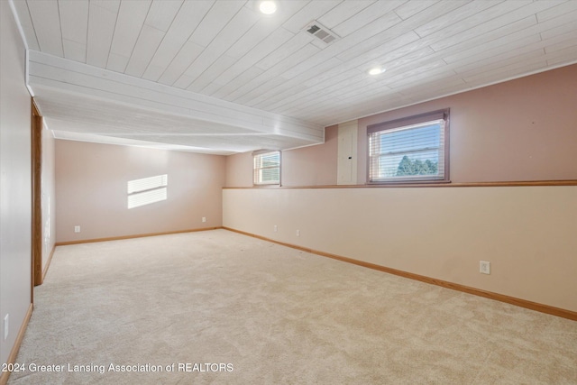 basement with wood ceiling and light colored carpet