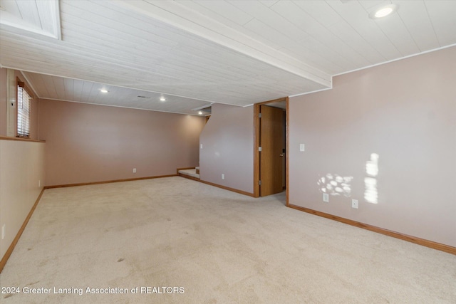 basement featuring light carpet