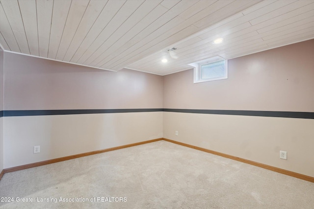 interior space featuring carpet flooring and wooden ceiling