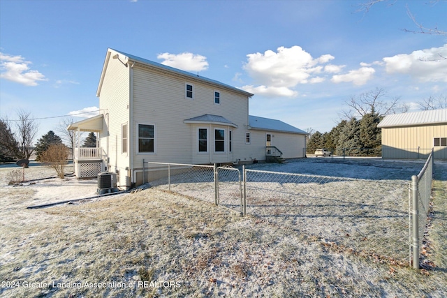 back of house with central AC