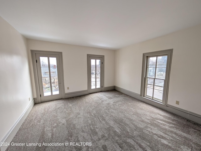 unfurnished room featuring carpet