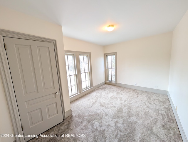 unfurnished room with light carpet