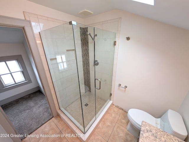 bathroom featuring a shower with shower door, tile patterned floors, toilet, and lofted ceiling