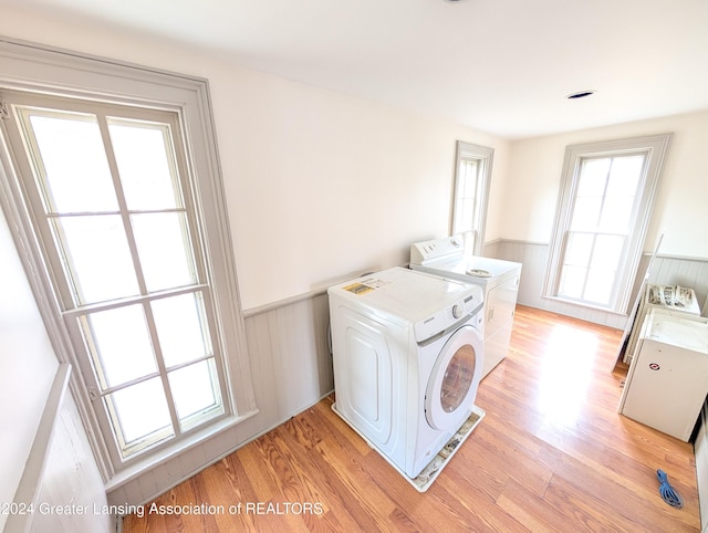 laundry room with light hardwood / wood-style flooring and independent washer and dryer