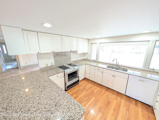 kitchen featuring white cabinets, dishwasher, range with electric cooktop, and sink