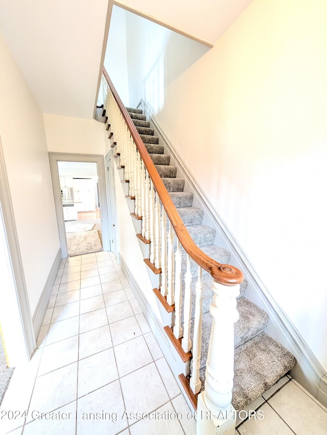 staircase with tile patterned floors