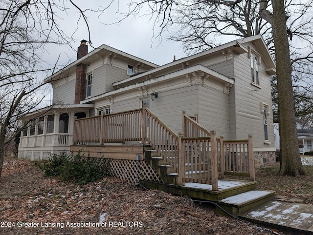 back of property featuring a deck