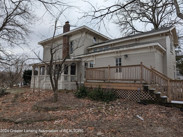 back of house featuring a deck