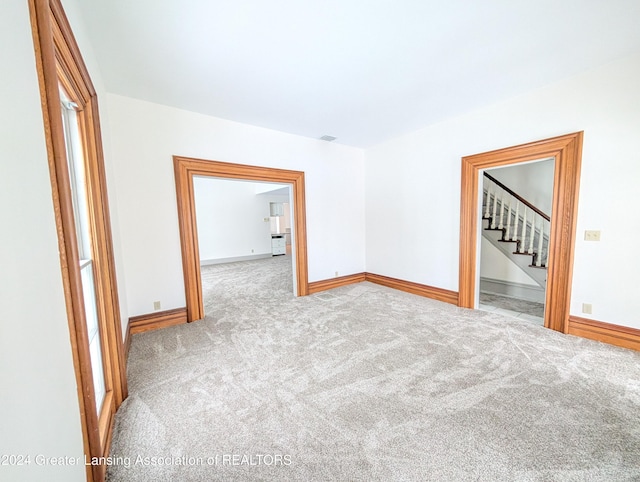 unfurnished room with light colored carpet