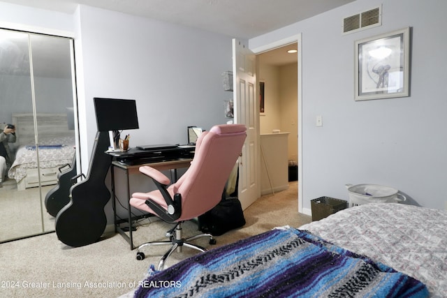 bedroom with light colored carpet and a closet