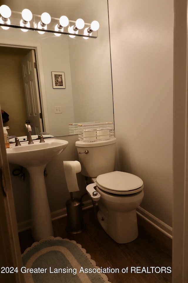 bathroom with toilet and hardwood / wood-style flooring