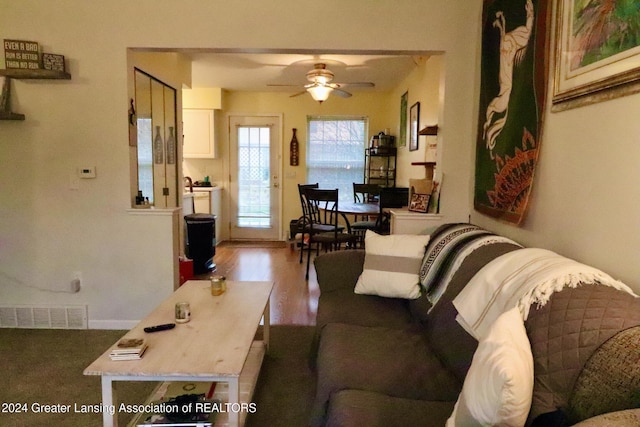 living room with hardwood / wood-style floors and ceiling fan