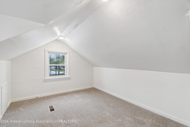 bonus room featuring carpet and vaulted ceiling