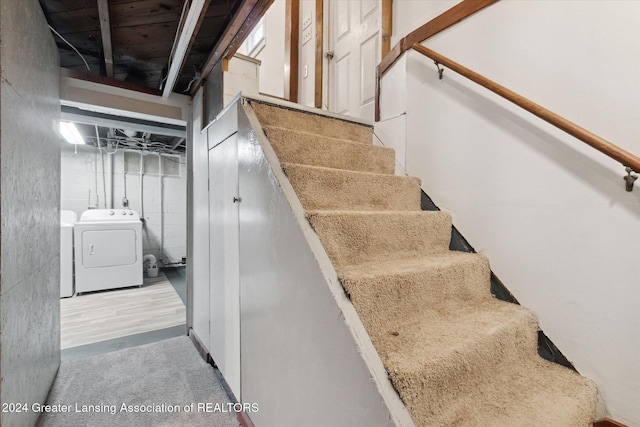 stairs featuring washer / dryer