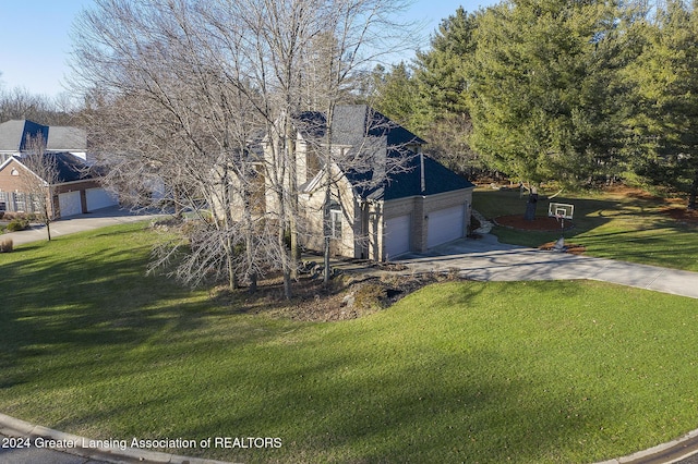 view of front of house with a garage and a front lawn