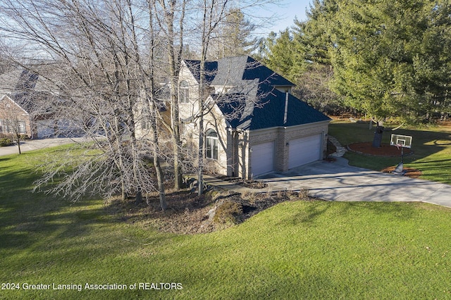 view of front of home with a front yard, a garage, and solar panels