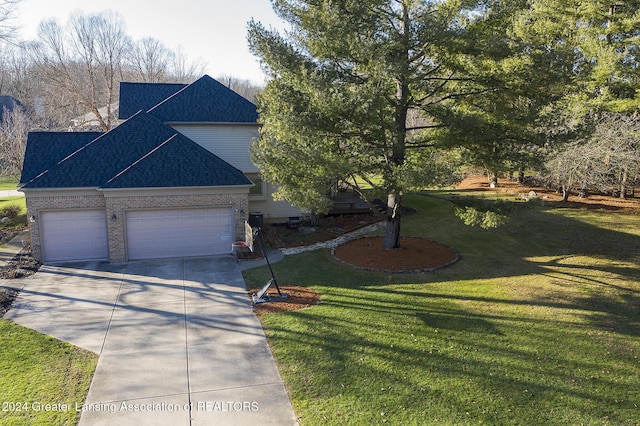 view of front facade with a front yard and a garage