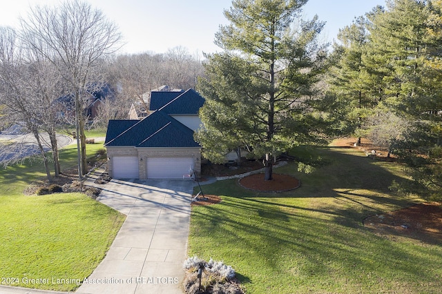 view of front of property with a front yard and a garage