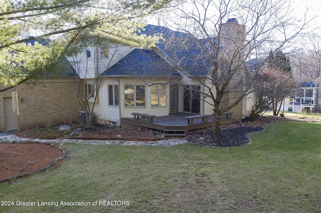 exterior space featuring a deck and a lawn