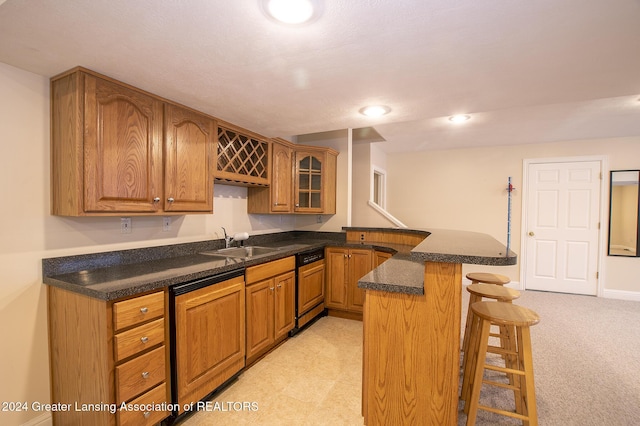 kitchen featuring sink, a kitchen breakfast bar, black dishwasher, and kitchen peninsula