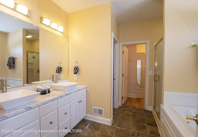 bathroom featuring vanity and plus walk in shower