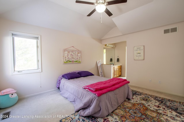 carpeted bedroom with ceiling fan, a wall mounted air conditioner, and vaulted ceiling