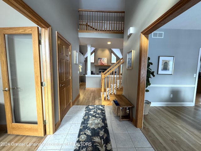 interior space with a high ceiling and light hardwood / wood-style flooring