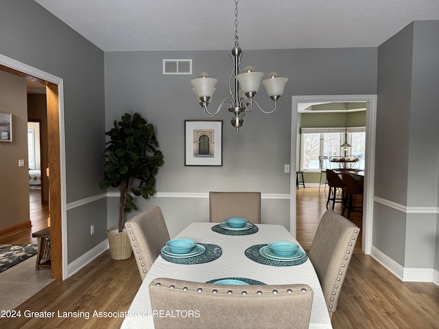 dining room featuring a notable chandelier and hardwood / wood-style floors