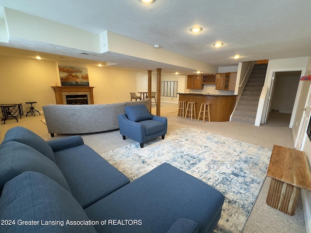 living room featuring indoor bar and light carpet