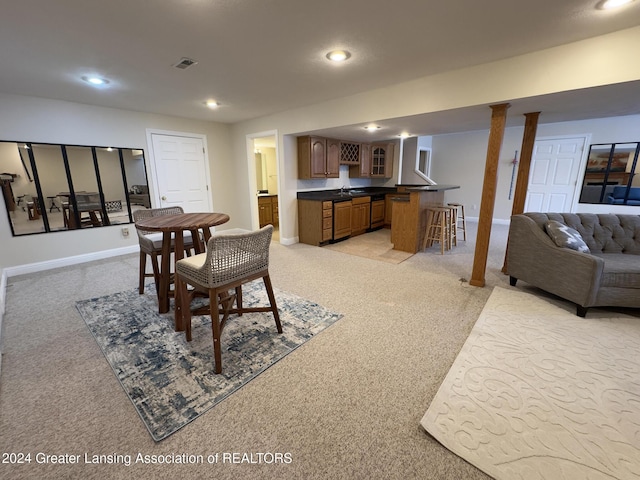 dining area with bar and light colored carpet