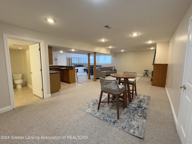 dining room featuring light carpet